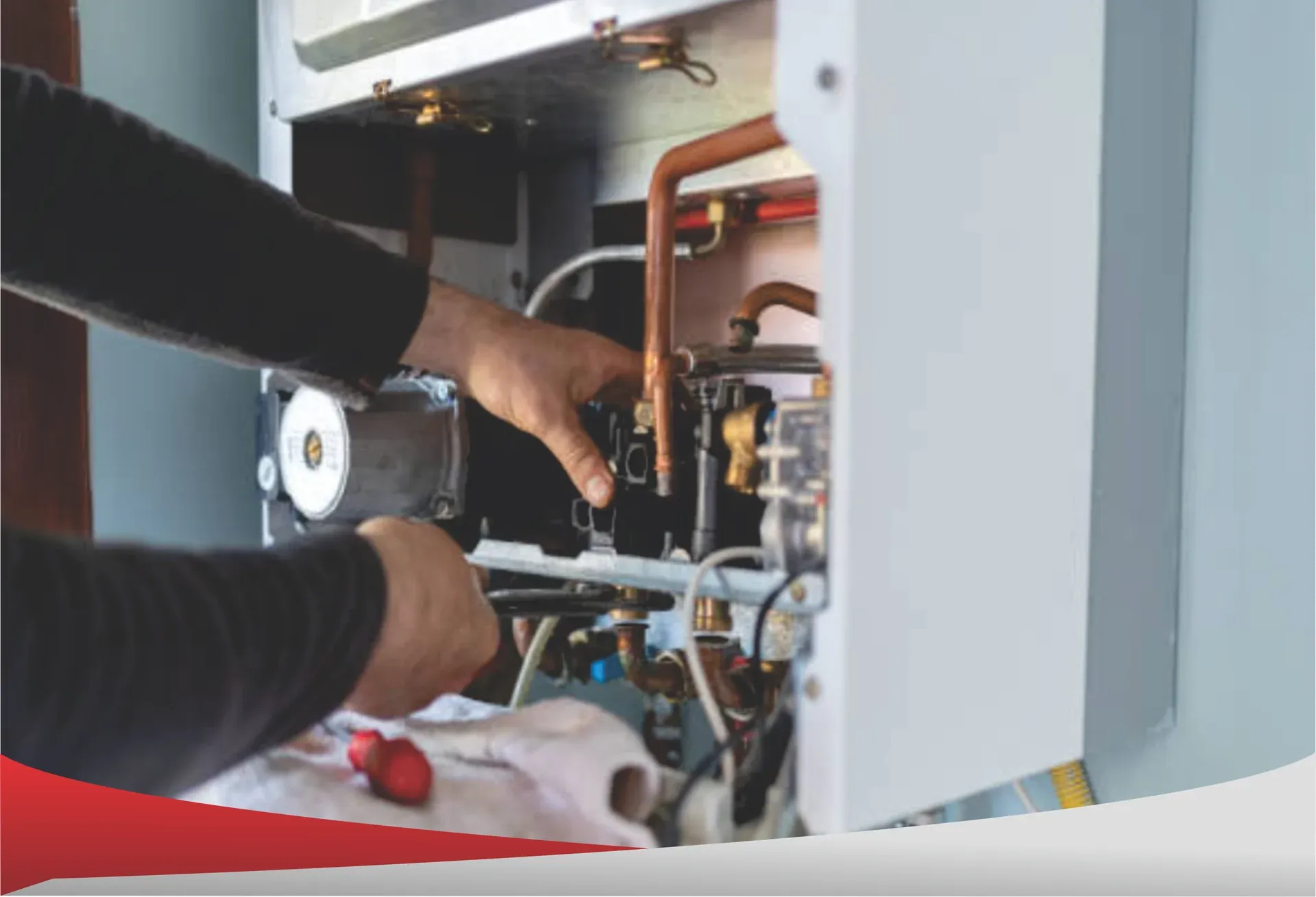 Technician servicing the gas control valve on a water heater in Chula Vista